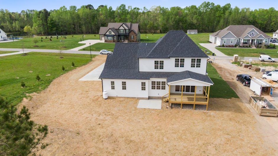 Aerial shot of a suburban home under construction in Youngsville, NC with surrounding greenery.